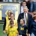 Representatives for former Michigan football player Bennie Oosterbann walk onto the field during a ceremony before the game at Michigan Stadium on Saturday. Melanie Maxwell I AnnArbor.com